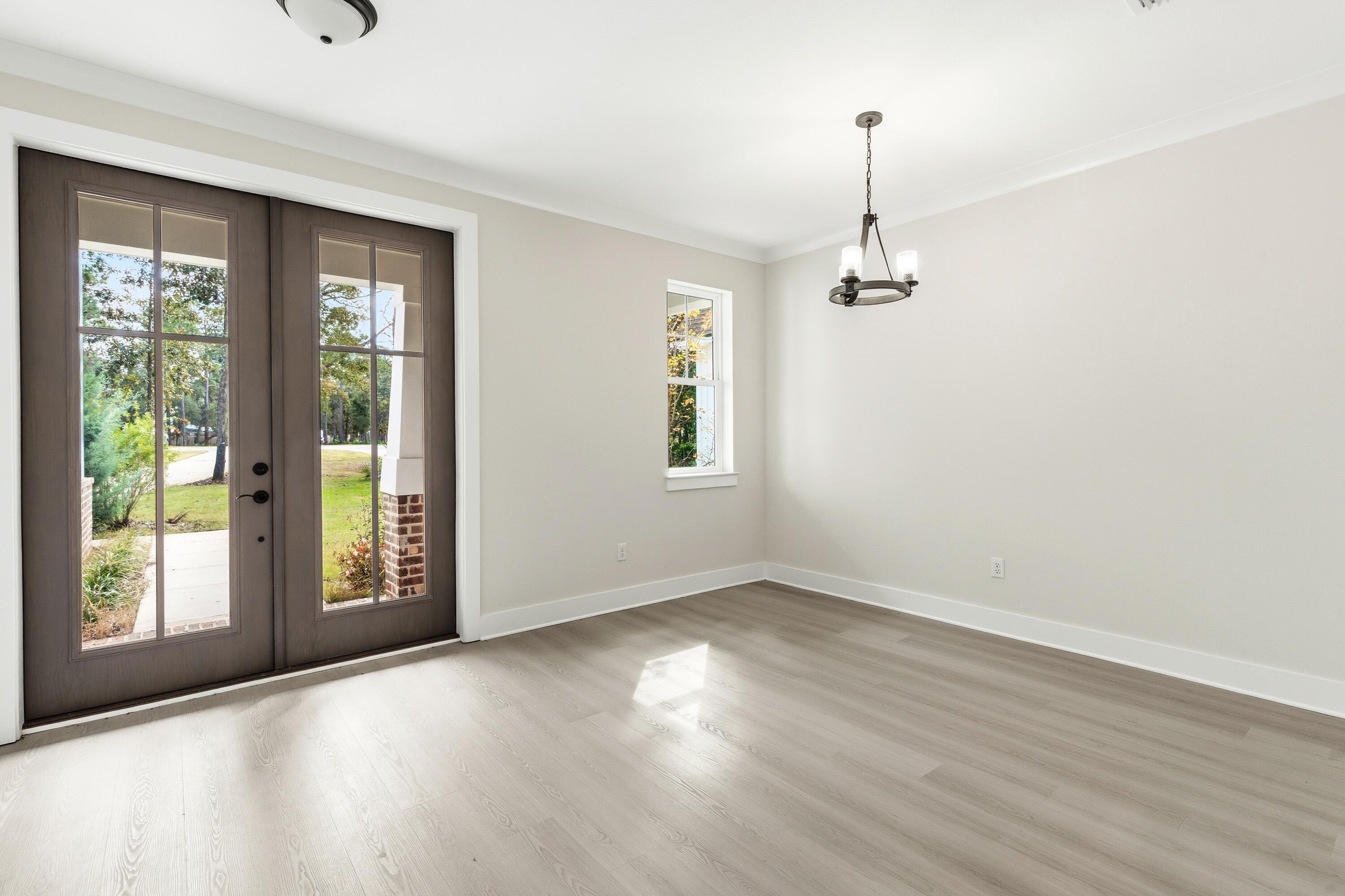 151 Redfish Pt Drive Freeport, FL 32439 - Photo 17 of 40 a view of an empty room with wooden floor and a window