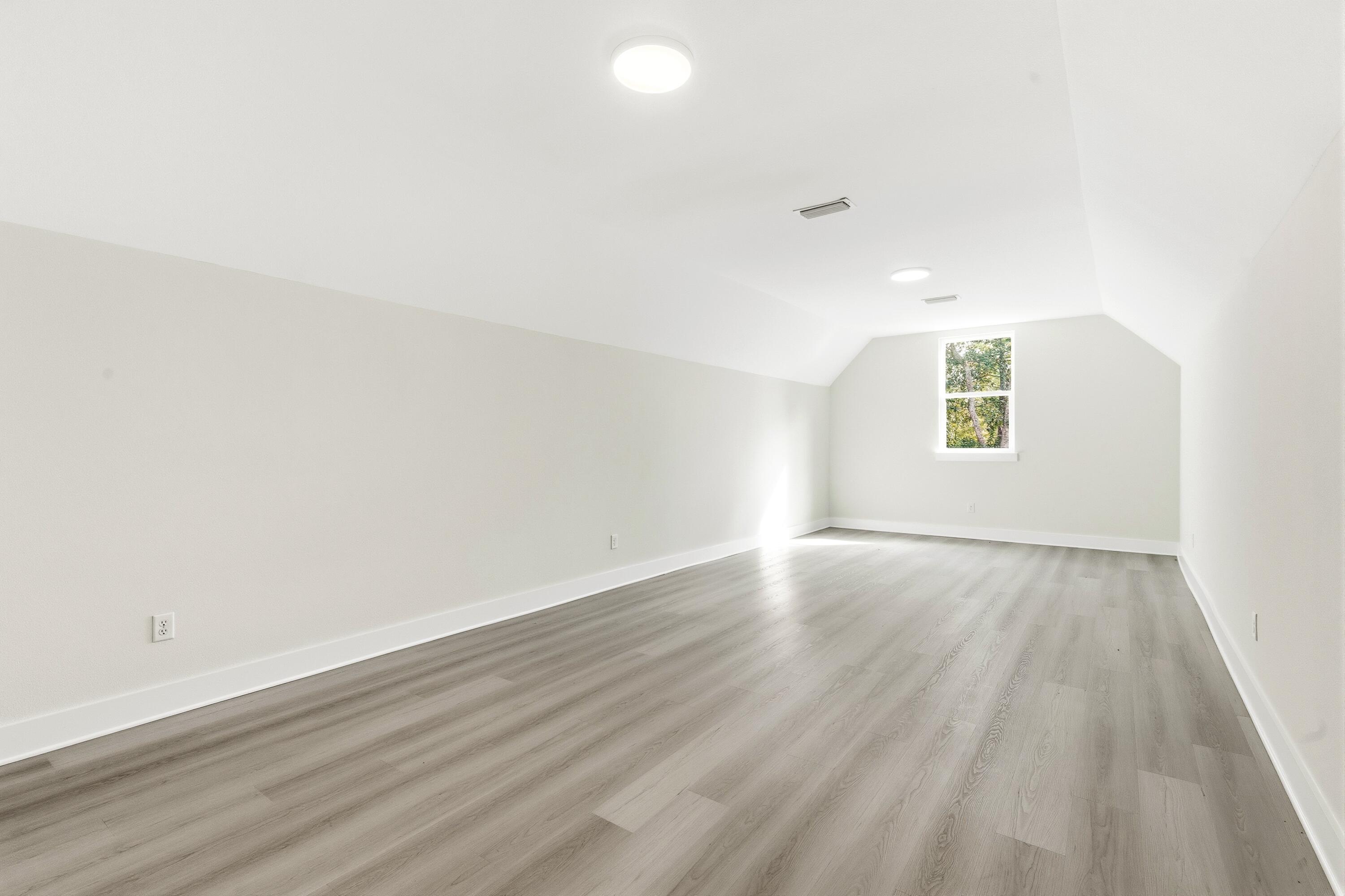 151 Redfish Pt Drive Freeport, FL 32439 - Photo 31 of 40 an empty room with wooden floor and windows