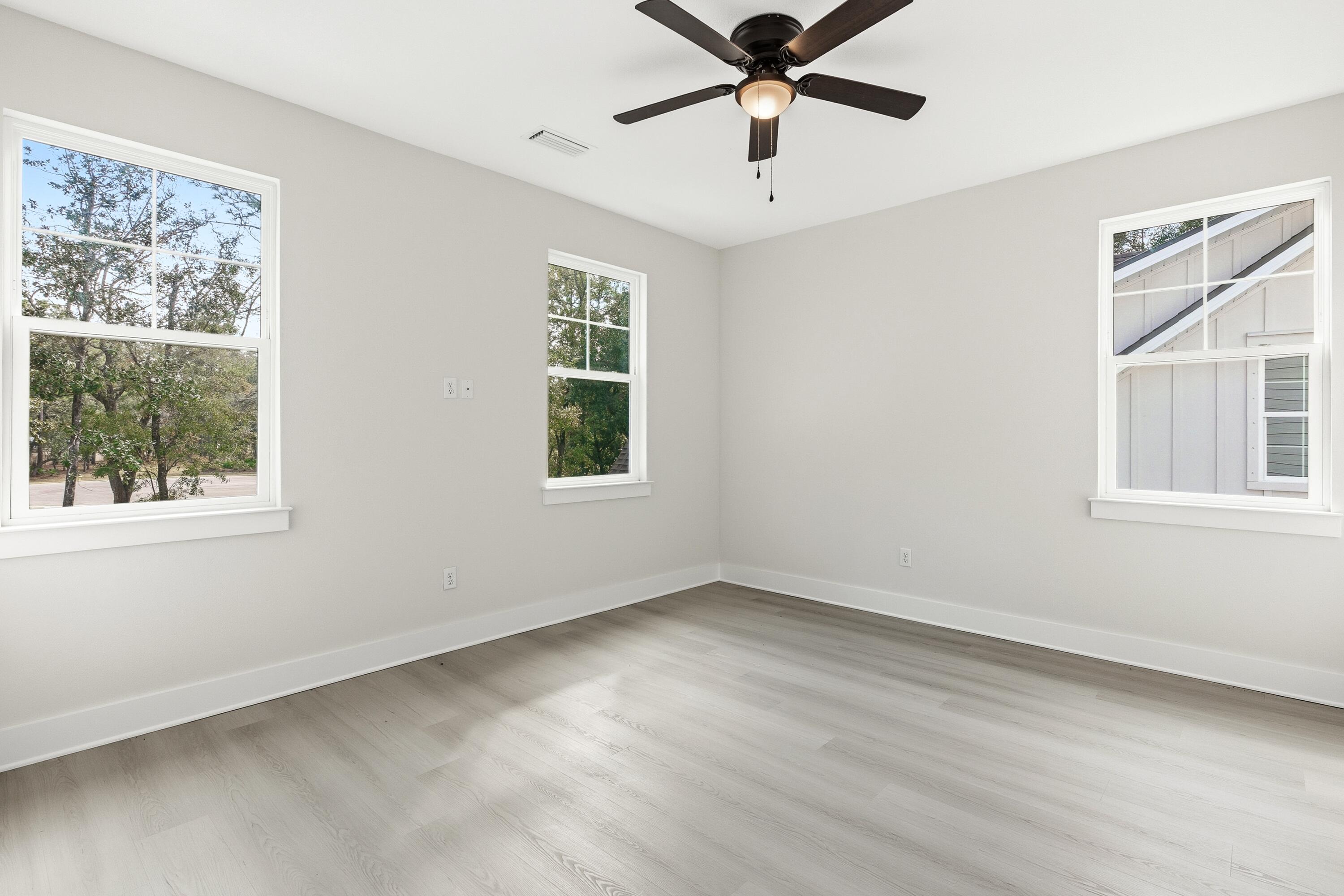 151 Redfish Pt Drive Freeport, FL 32439 - Photo 32 of 40 a view of an empty room with a window and wooden floor