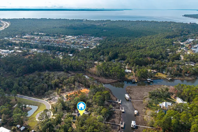 an aerial view of a house with a yard