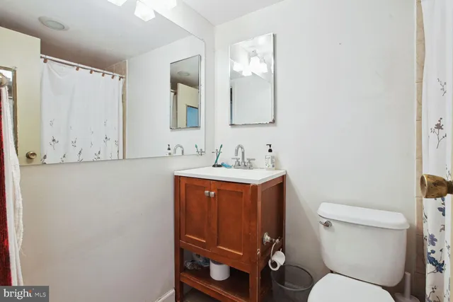 a bathroom with a toilet sink and mirror
