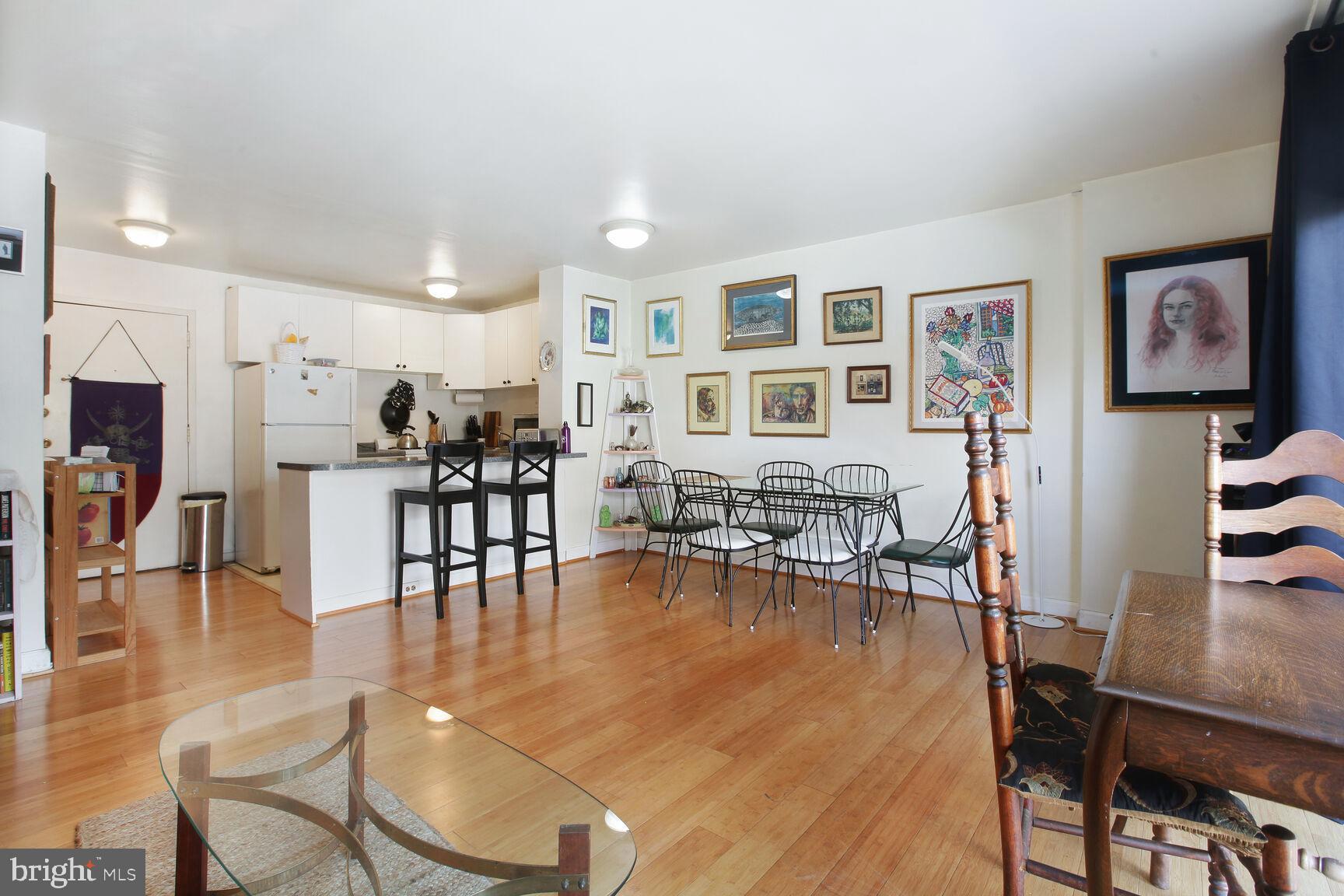 950 25th Street Northwest, Unit 608N Washington, DC 20037 - Photo 5 of 38 a living room with furniture and kitchen view with wooden floor