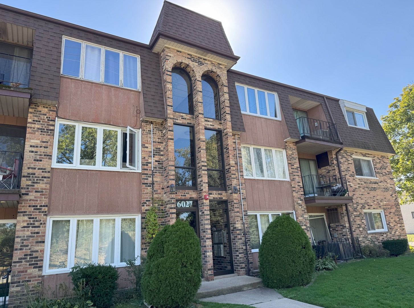 6027 103rd Street, Unit 1A Chicago Ridge, IL 60415 - Photo 20 of 22 a front view of a house with a garden