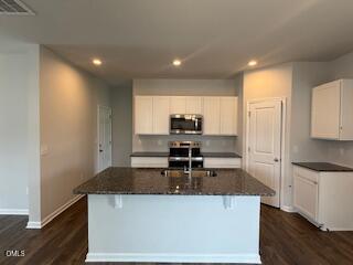 41 Stout Landing Dunn, NC 28334 - Photo 13 of 33 a kitchen with stainless steel appliances granite countertop a sink a stove and a refrigerator