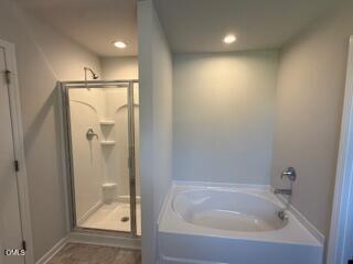 41 Stout Landing Dunn, NC 28334 - Photo 25 of 33 a bathroom with a glass shower door and a bathtub