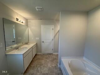 41 Stout Landing Dunn, NC 28334 - Photo 32 of 33 a spacious bathroom with a tub sink and mirror