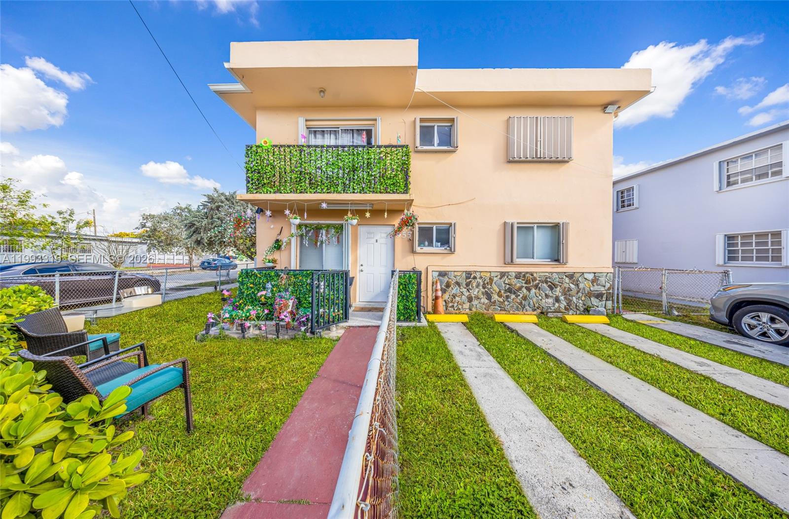 955 West 23rd Street Hialeah, FL 33010 - Photo 2 of 16 a front view of a house with swimming pool having outdoor seating