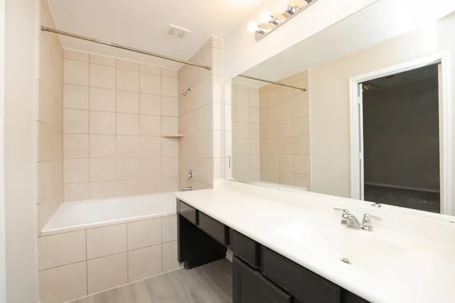 a bathroom with a bathtub a sink and a shower