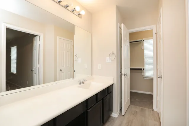 a bathroom with a double vanity sink and mirror
