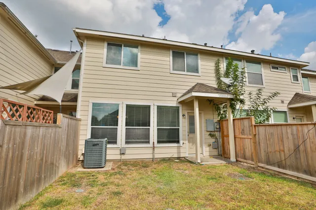 a view of a house with wooden fence