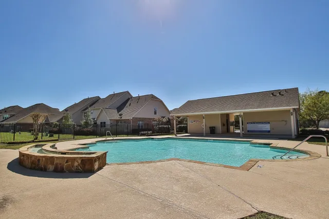 a view of a house with a yard and palm tree