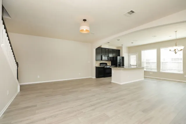 a view of a kitchen with a sink and a stove top oven