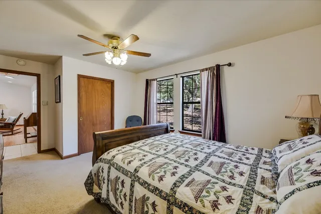 a bedroom with a large bed and a chandelier