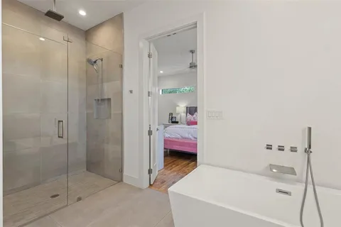 a en suite bathroom with a tub shower and sink