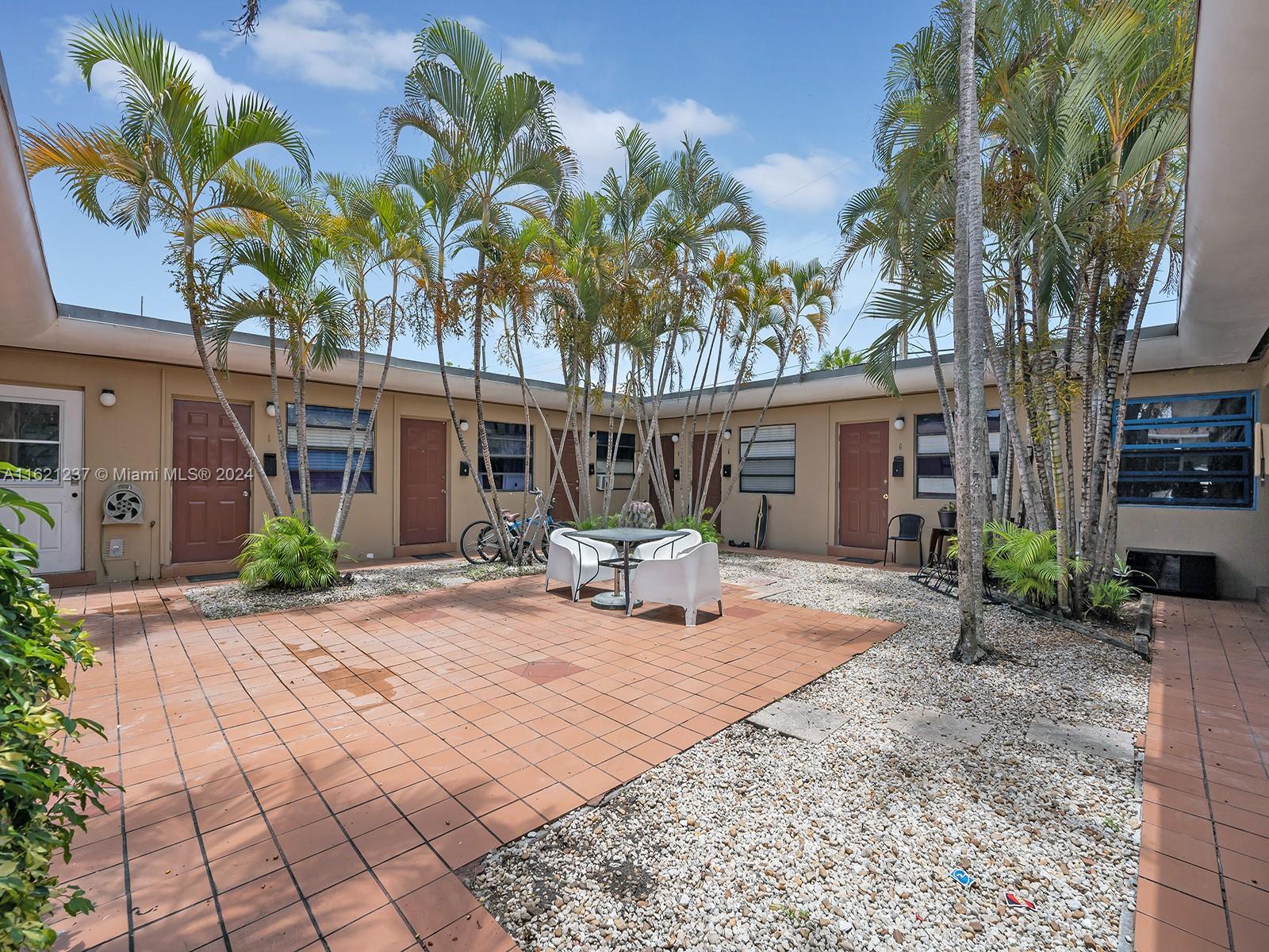 700 Northeast 6th Street Hallandale Beach, FL 33009 - Photo 13 of 15 a view of a backyard with a sitting area and furniture