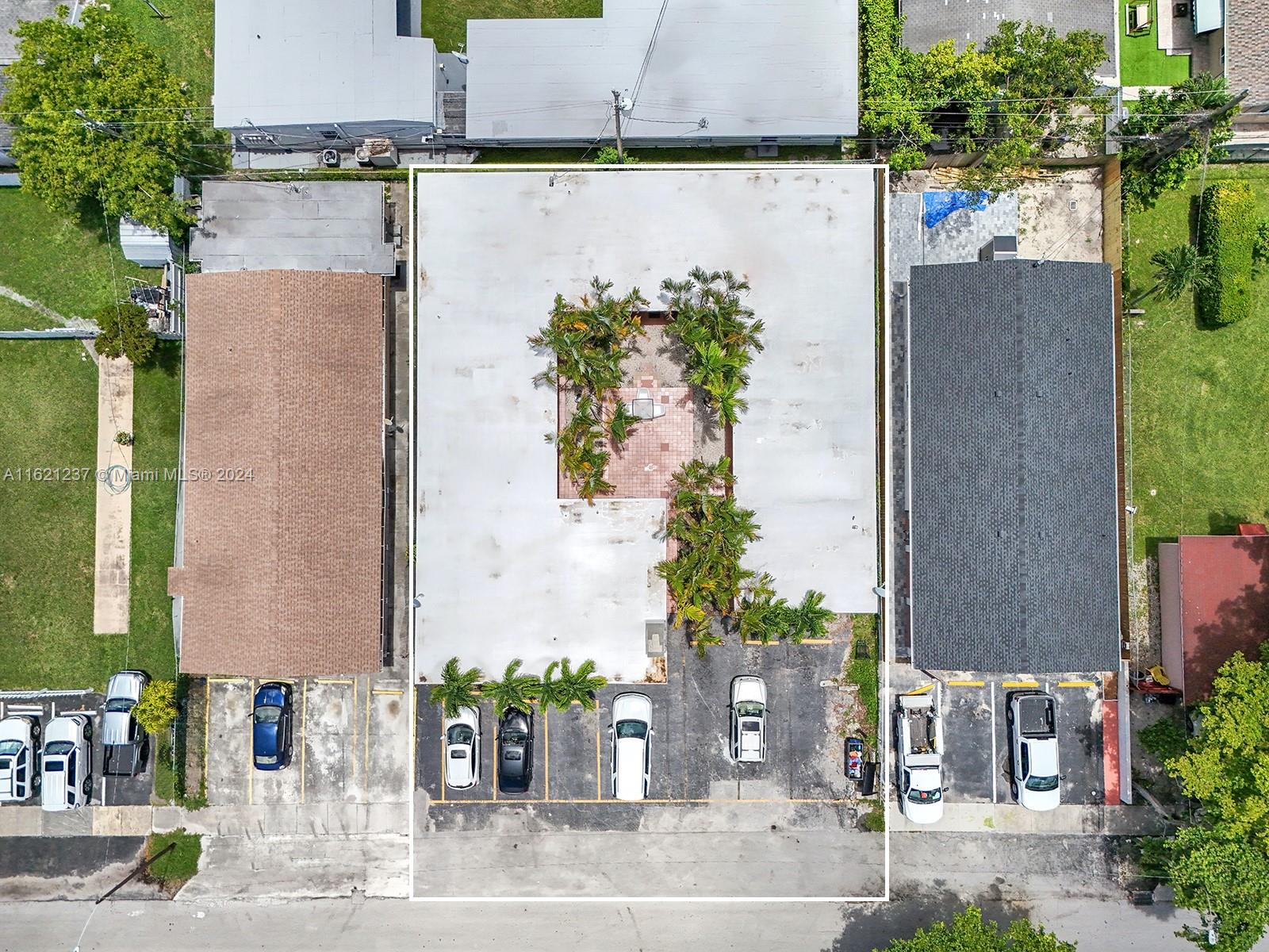 700 Northeast 6th Street Hallandale Beach, FL 33009 - Photo 3 of 15 an aerial view of a house with a yard and a fountain
