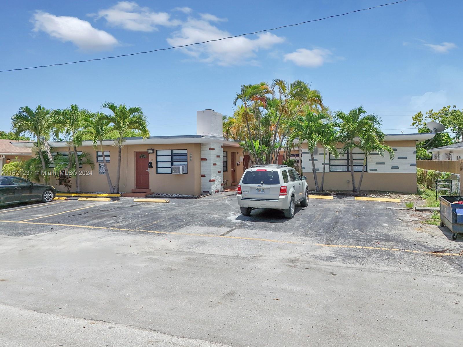 700 Northeast 6th Street Hallandale Beach, FL 33009 - Photo 7 of 15 a view of a car parked in front of a house