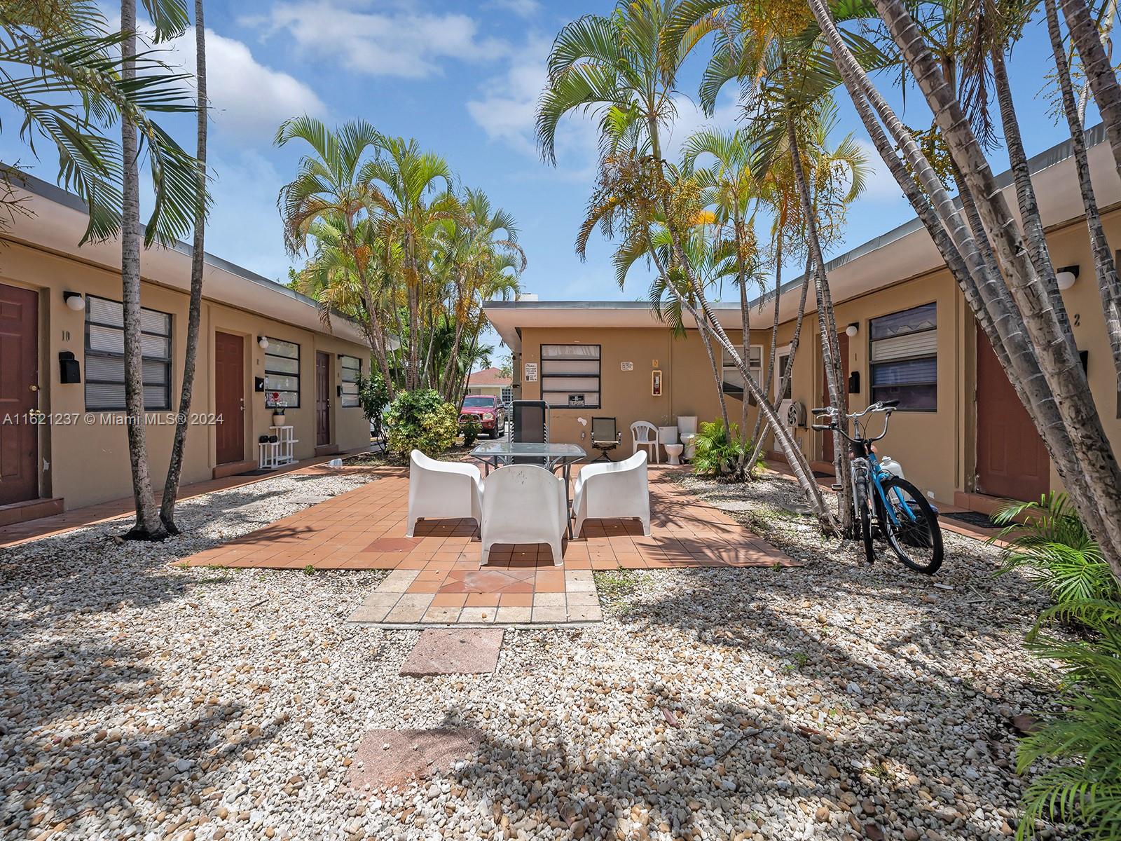 700 Northeast 6th Street Hallandale Beach, FL 33009 - Photo 9 of 15 a view of a backyard with a table and chairs