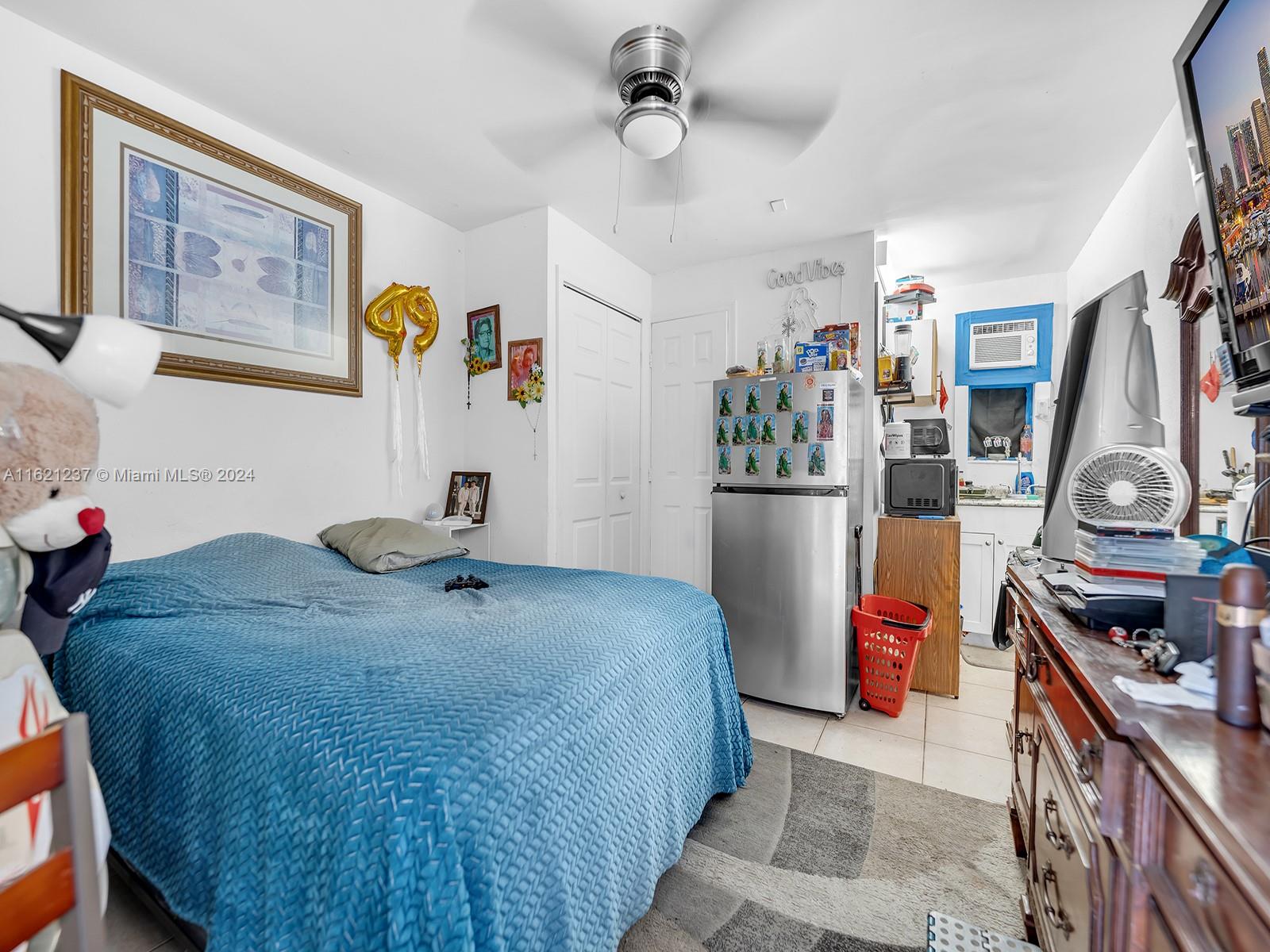 700 Northeast 6th Street Hallandale Beach, FL 33009 - Photo 10 of 15 a bedroom with a bed and cabinets