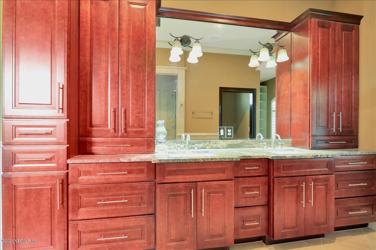 96270 Captains Pointe Road Yulee, FL 32097 - Photo 13 of 34 a bathroom with a granite countertop sink and a mirror