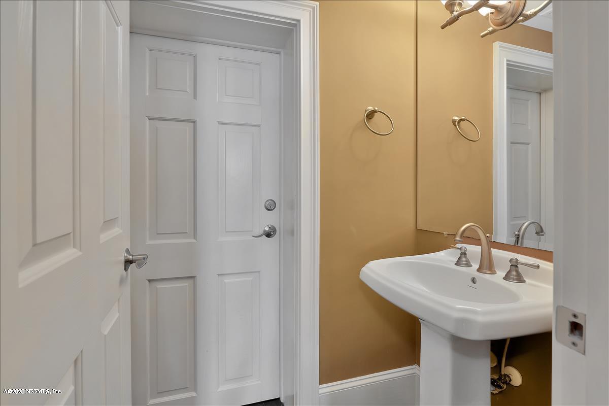 96270 Captains Pointe Road Yulee, FL 32097 - Photo 22 of 34 a bathroom with a sink and mirror