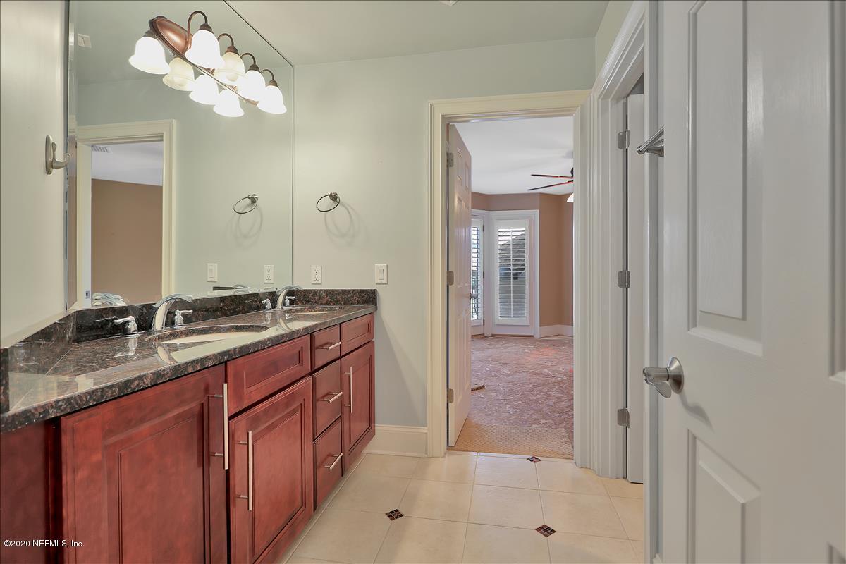 96270 Captains Pointe Road Yulee, FL 32097 - Photo 24 of 34 a bathroom with a granite countertop sink a mirror and a shower