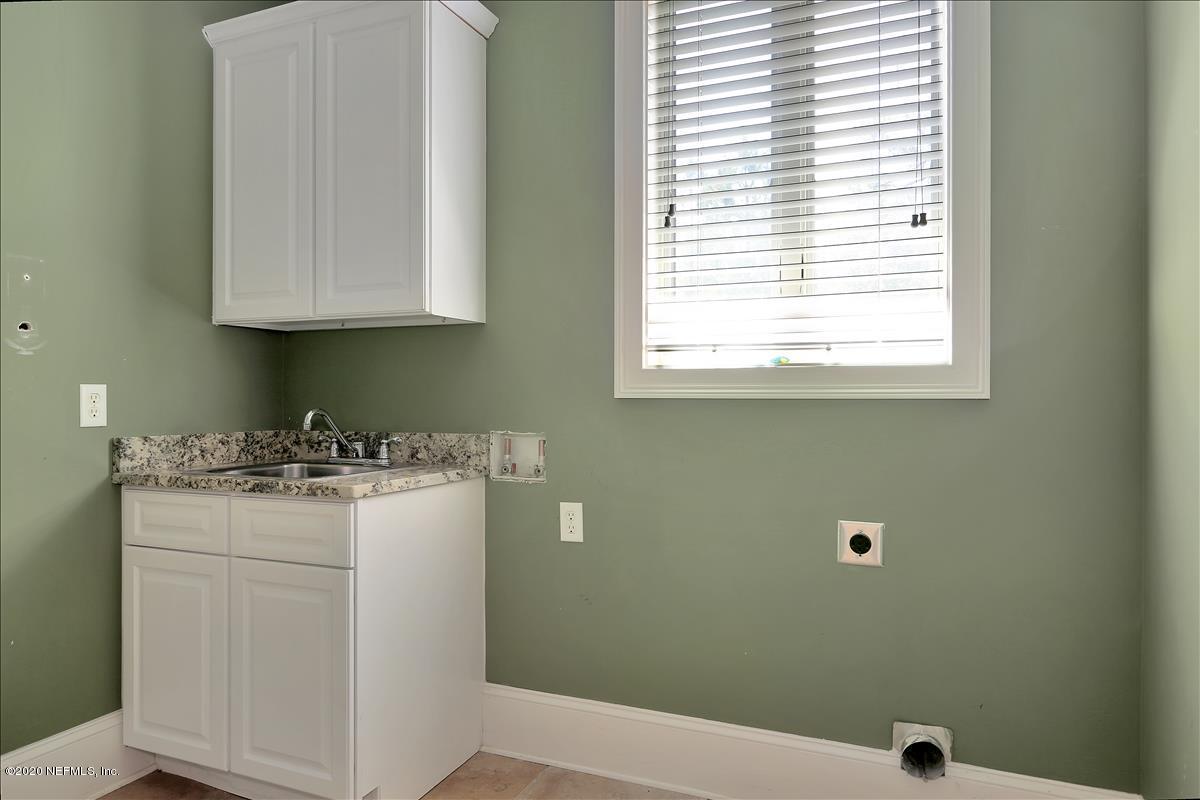 96270 Captains Pointe Road Yulee, FL 32097 - Photo 26 of 34 a bathroom with a sink a vanity and a window