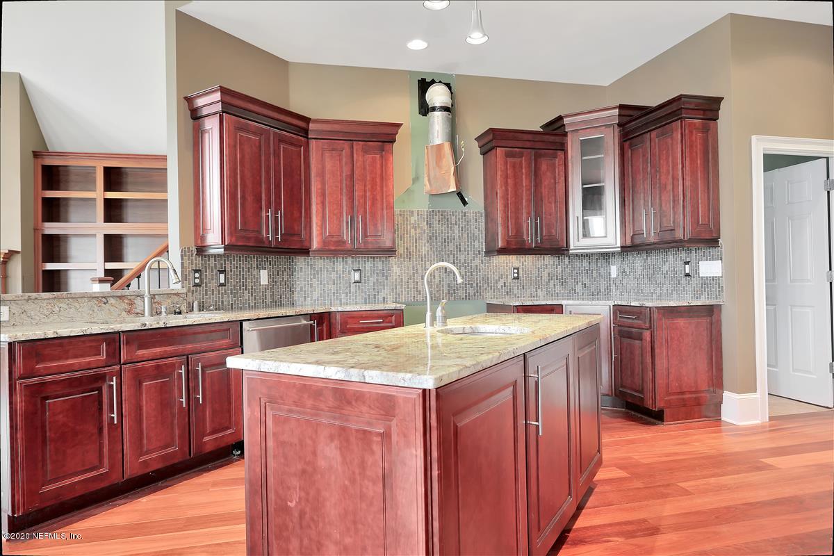 96270 Captains Pointe Road Yulee, FL 32097 - Photo 4 of 34 a kitchen with stainless steel appliances granite countertop wooden cabinets a sink and dishwasher a stove with wooden floor