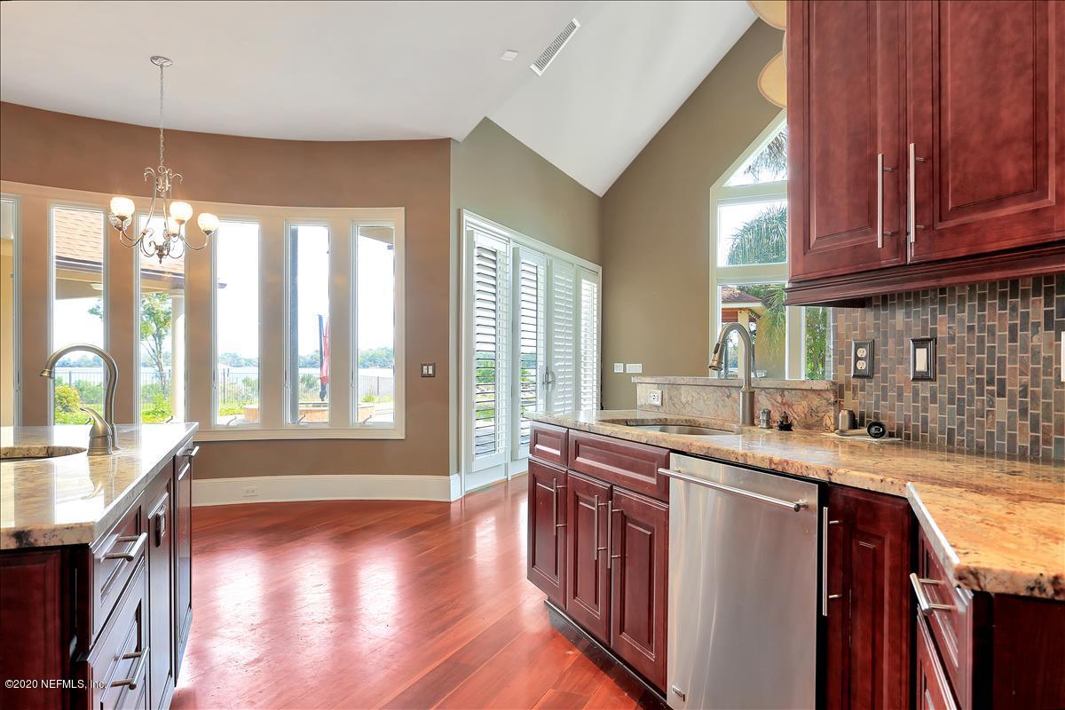 96270 Captains Pointe Road Yulee, FL 32097 - Photo 8 of 34 a kitchen with stainless steel appliances granite countertop a sink a stove cabinets and wooden floor