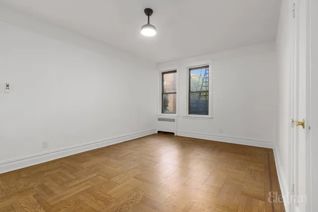 an empty room with windows and closet