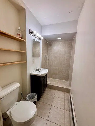 a bathroom with a sink a toilet a mirror and bathtub