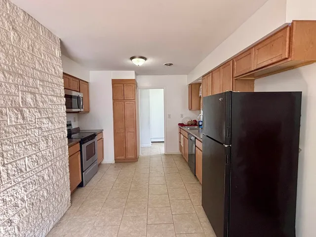 a kitchen with a refrigerator and a sink