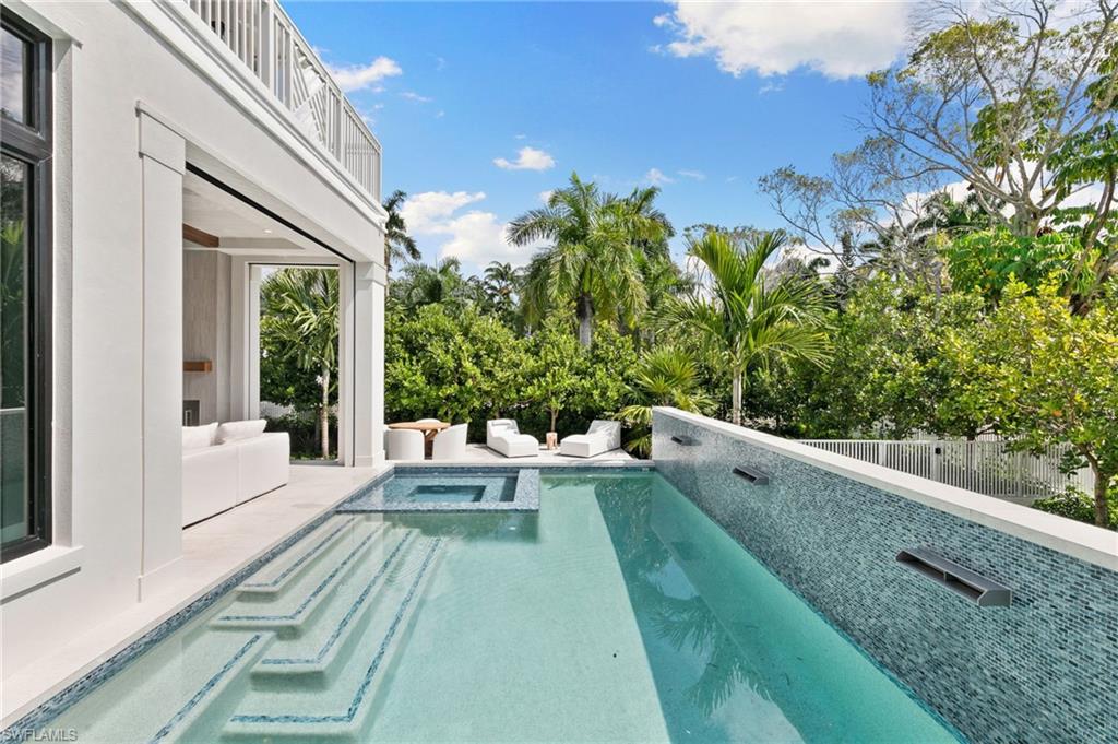 1191 7th Avenue North Naples, FL 34102 - Photo 22 of 49 Spectacular Outside Pool, Wall of Blue Tile offers bring the soothing sounds of trickling Waterfalls and integrated Spa