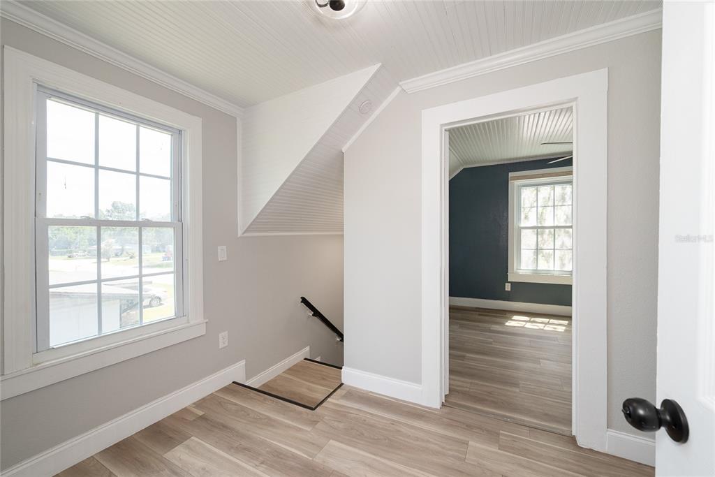 922 Delaware Avenue St. Cloud, FL 34769 - Photo 17 of 31 an empty room with wooden floor and windows