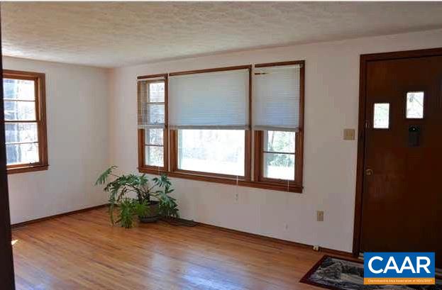 5630 Fitzgerald Road Charlottesville, VA 22903 - Photo 4 of 28 a view of an empty room with wooden floor and a window