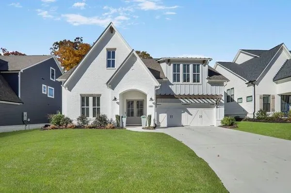 a front view of a house with a garden and plants