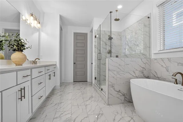 a bathroom with a double vanity sink a toilet a shower and a mirror