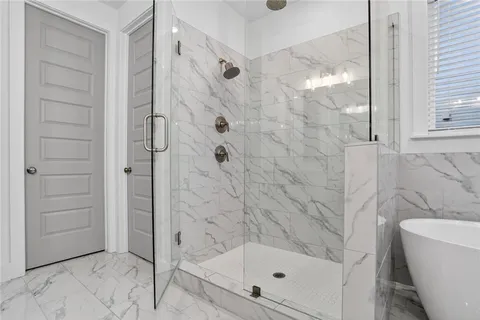 a bathroom with a bathtub and a shower