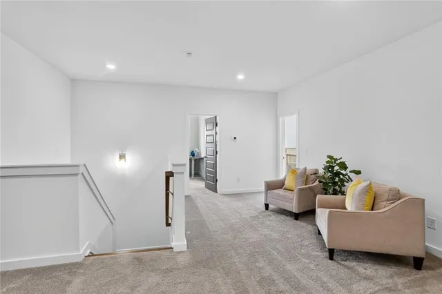 a living room with furniture and white walls