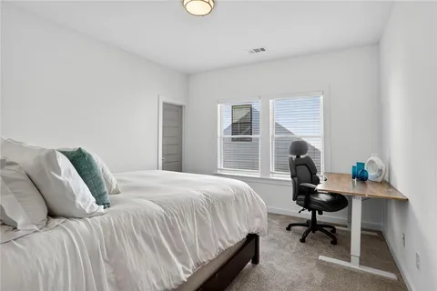 a bedroom with a bed a desk and chair