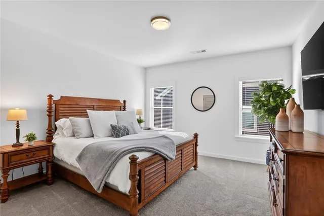 a bedroom with bed and a window