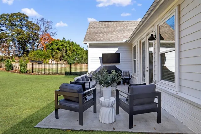 a view of a house with backyard and sitting area