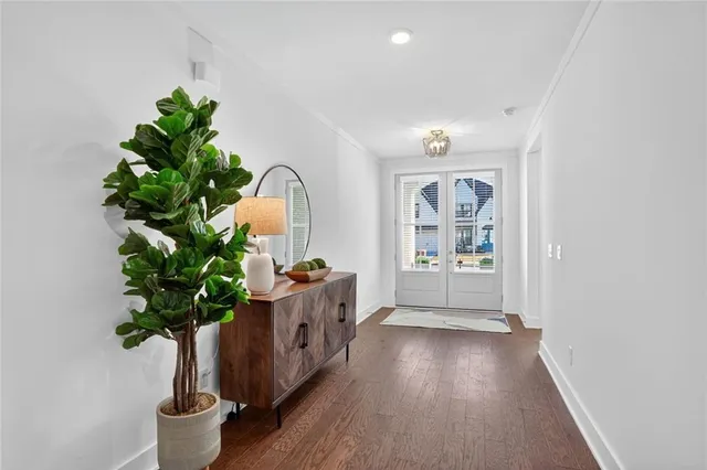 a view of hallway with furniture and a potted plant