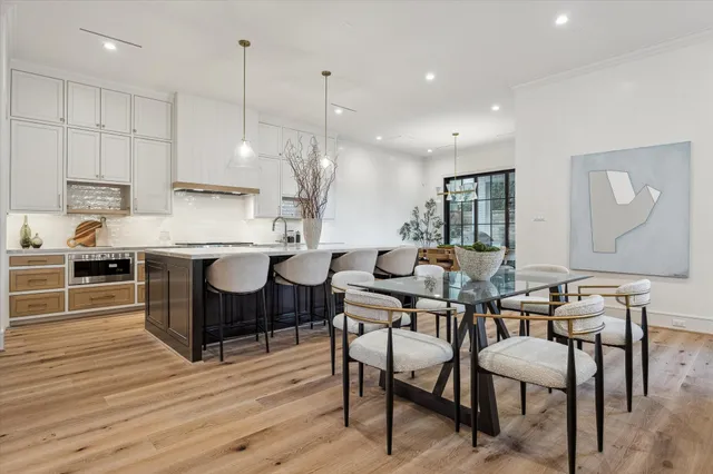 a kitchen with a table chairs stove and cabinets