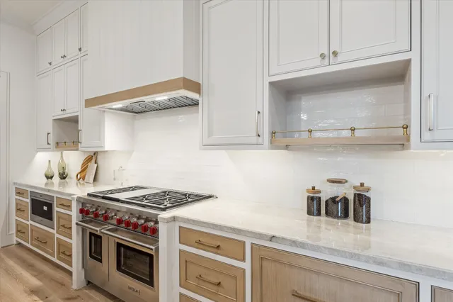 a kitchen with stainless steel appliances granite countertop a stove and a sink