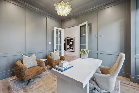 a living room with furniture and a chandelier