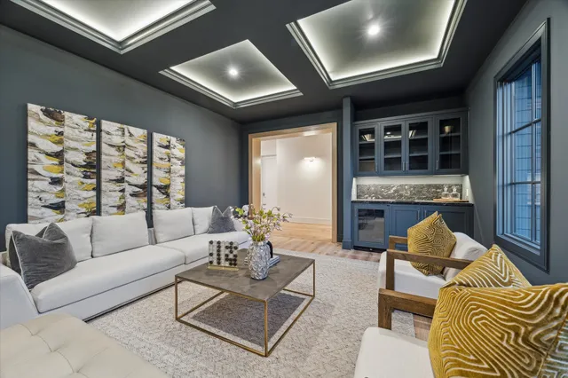 a living room with furniture lamp and window