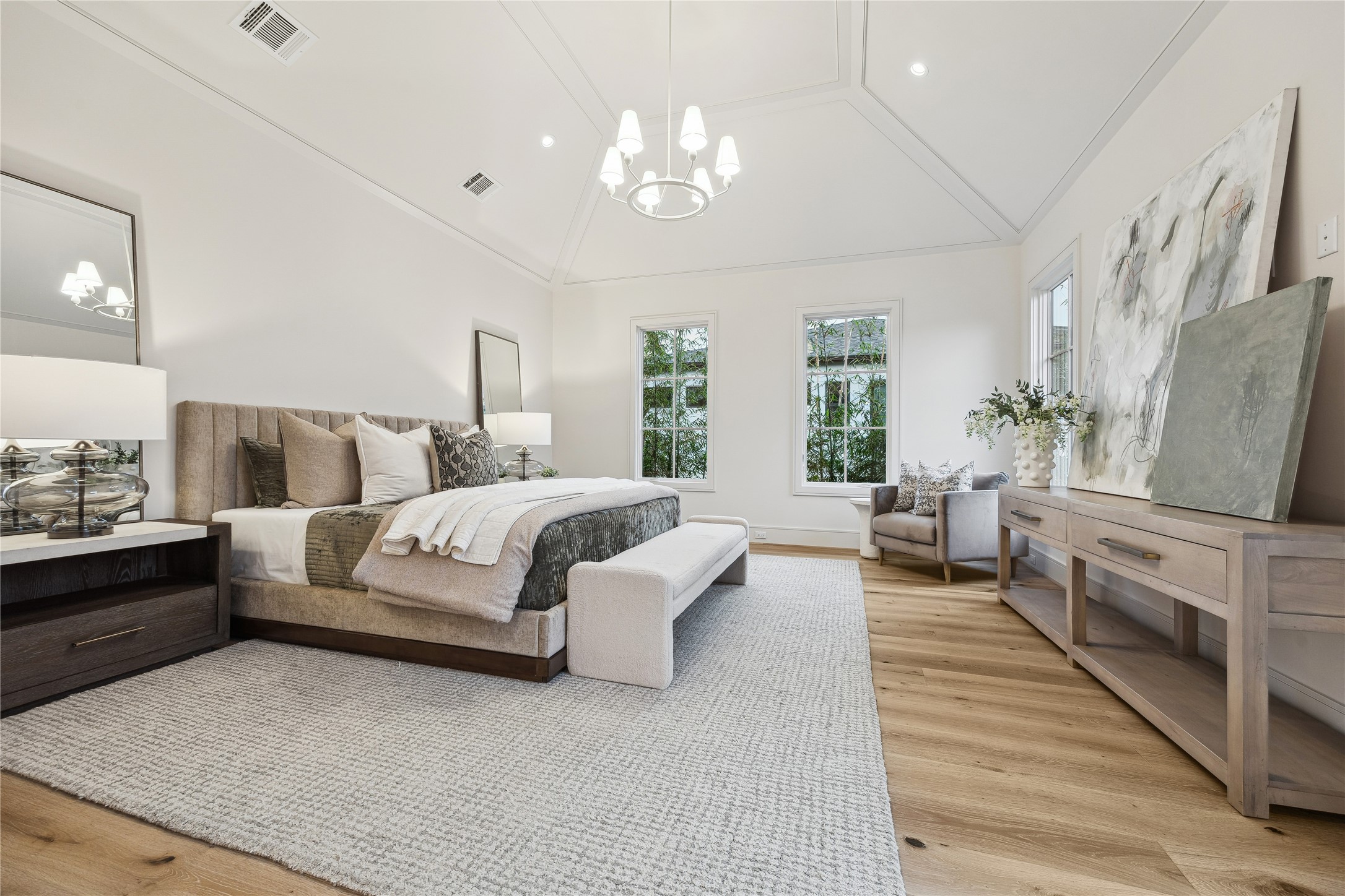 1210 West Drew Street Houston, TX 77006 - Photo 4 of 35 The primary bedroom is fit for royalty. Vaulted, 12-foot ceilings expand the space and multiple windows bring in natural light. A king bed and supplemental furniture will fit with ease.