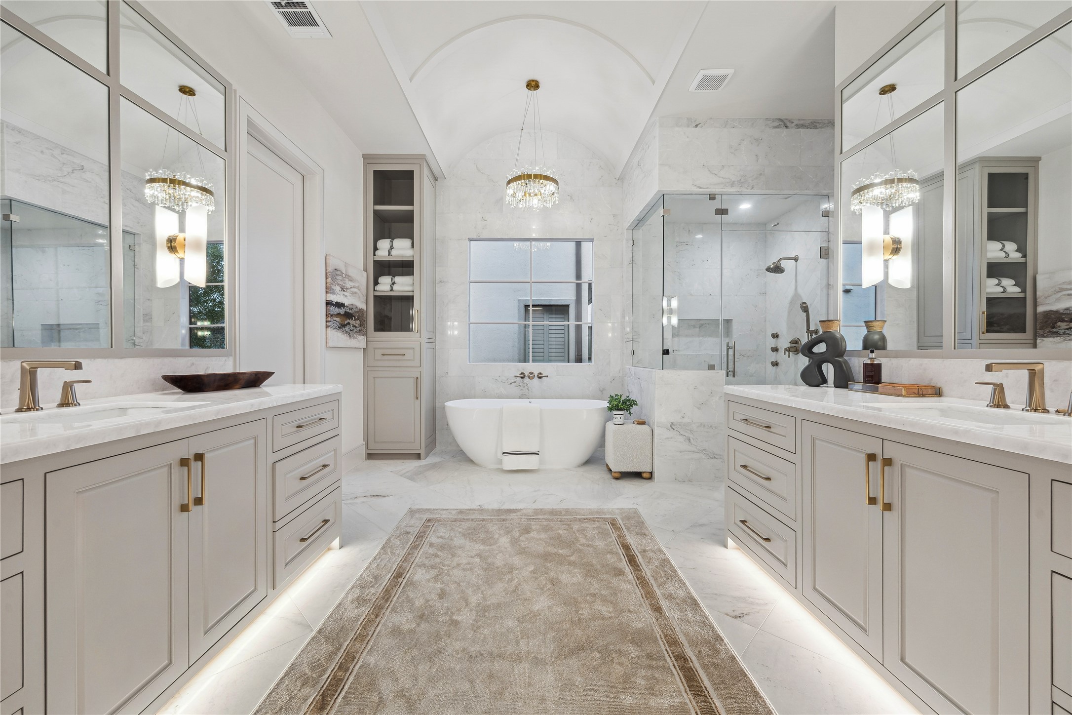 1210 West Drew Street Houston, TX 77006 - Photo 5 of 35 The pristine primary bath has a barreled ceiling centered over the sumptuous soaking tub with crystal chandelier. Large marble floor tiles add elegance. The shower is all marble and features multiple polished gold Brizo sprays. Double vanities make sharing easy!