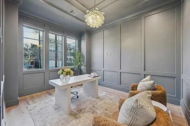 a living room with furniture and a chandelier